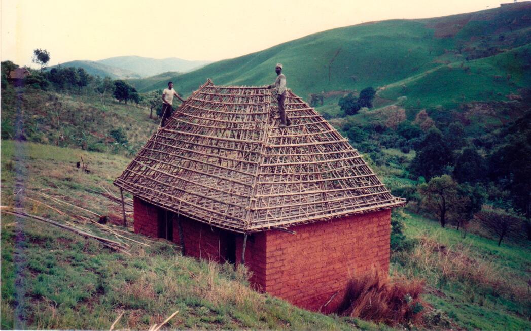 Men constructing thatched roof